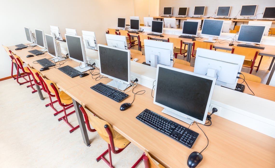 Computer class with rows of desktop computers in school